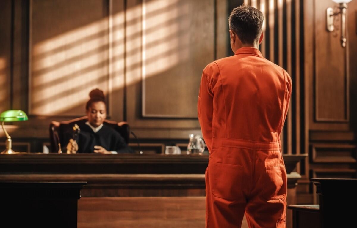 An inmate stands before a judge.