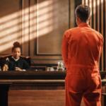 An inmate stands before a judge.