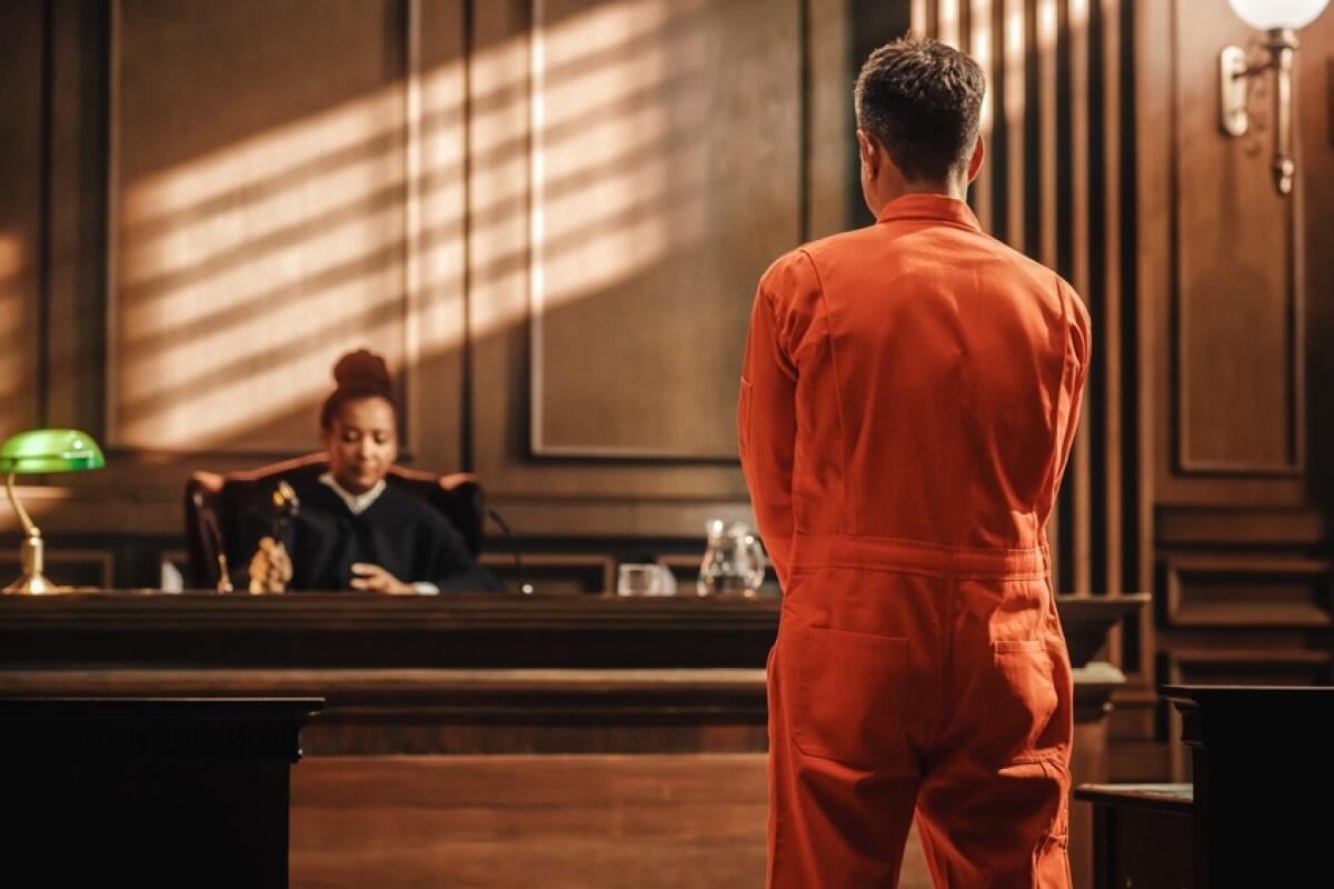 An inmate stands before a judge.