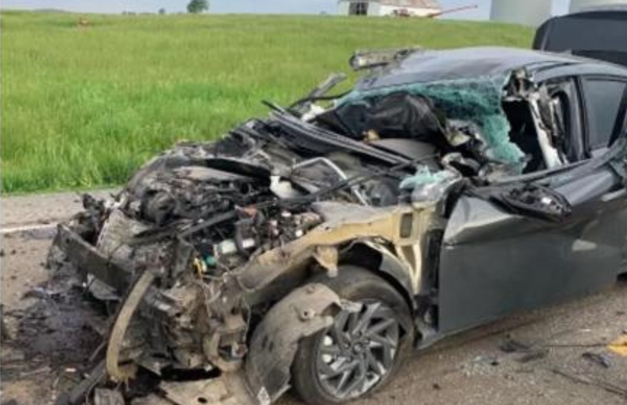 Damaged car after collision with farm equipment