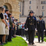 Uniformed officers honor the families of their fallen colleagues during the annual Police Officers Memorial on the Illinois State Capitol grounds Thursday in Springfield. Six fallen officers were honored at the ceremony. (Capitol News Illinois photo by Jerry Nowicki)