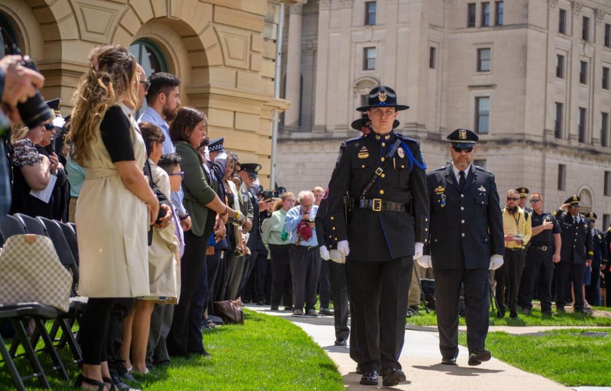 Uniformed officers honor the families of their fallen colleagues during the annual Police Officers Memorial on the Illinois State Capitol grounds Thursday in Springfield. Six fallen officers were honored at the ceremony. (Capitol News Illinois photo by Jerry Nowicki)