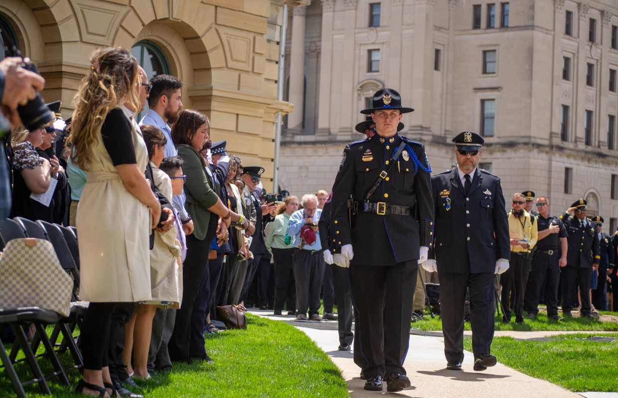 Uniformed officers honor the families of their fallen colleagues during the annual Police Officers Memorial on the Illinois State Capitol grounds Thursday in Springfield. Six fallen officers were honored at the ceremony. (Capitol News Illinois photo by Jerry Nowicki)