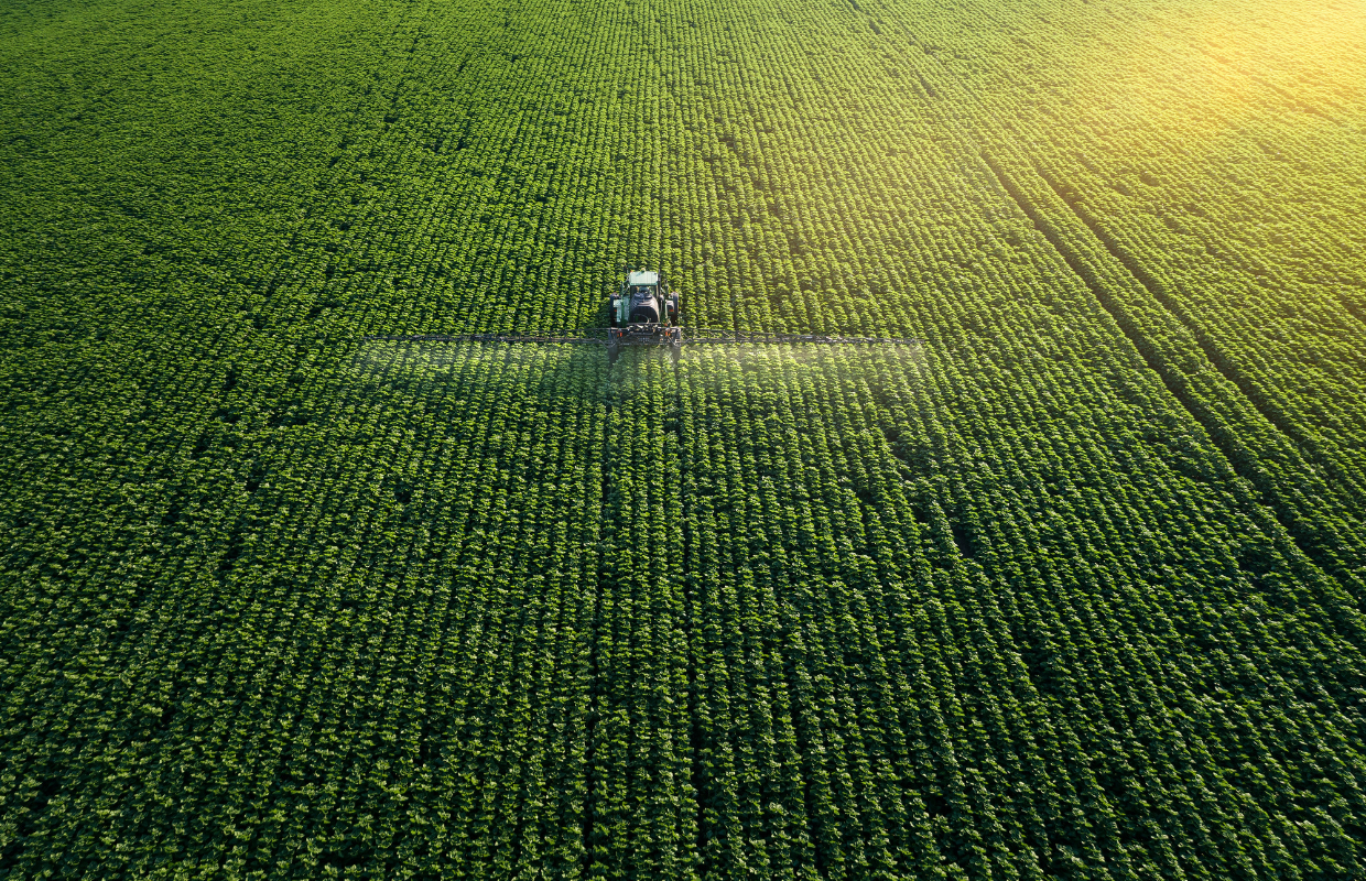Farmer fertilizing field