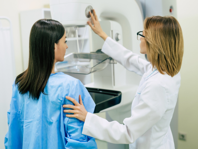 Woman receiving mammogram