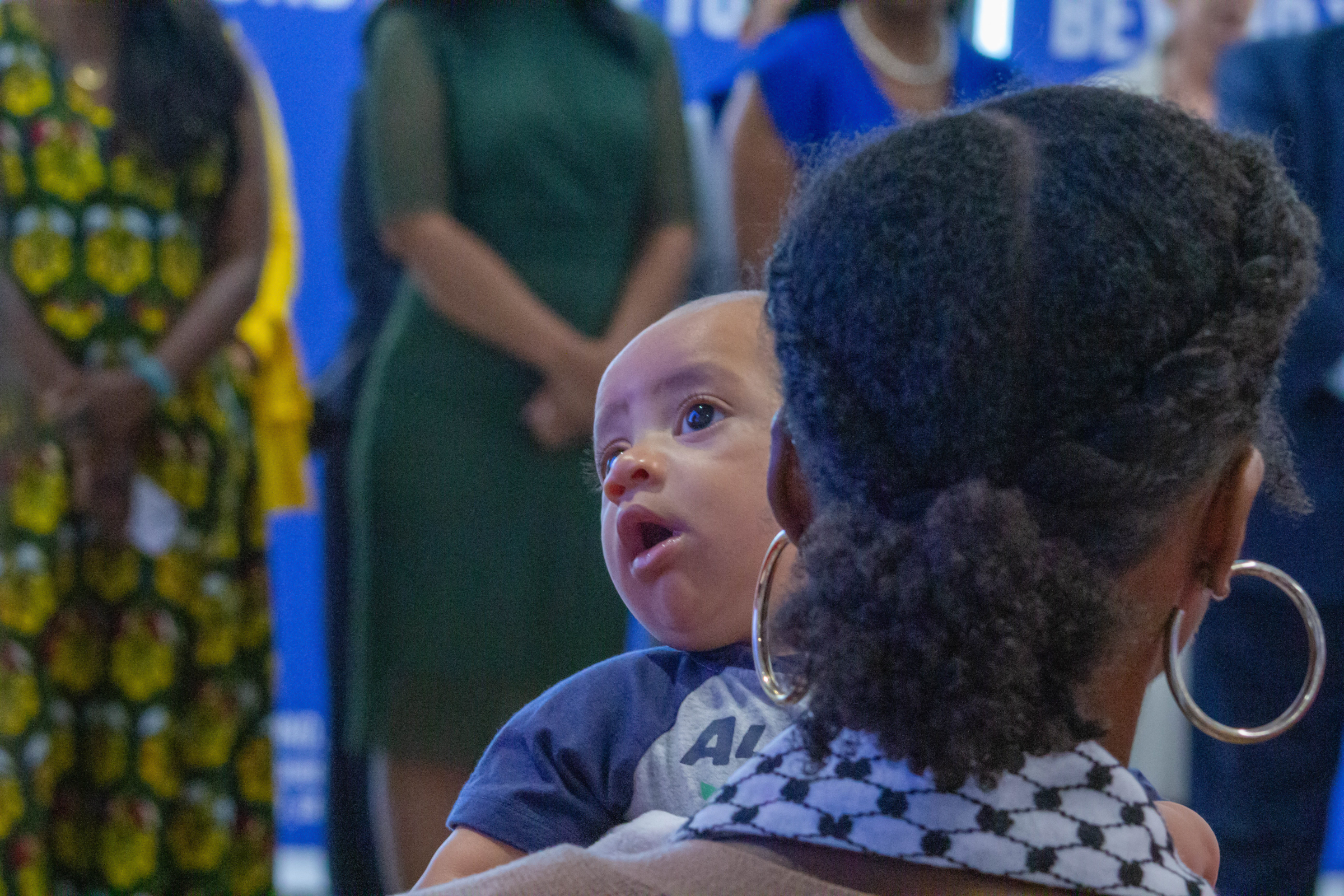 An infant and audience member sit in the crowd of a news conference in Chicago’s Fulton Market District neighborhood. Gov. JB Pritzker signed House Bill 5142 into law, with the hope of lowering infant and maternal mortality rates across the state.