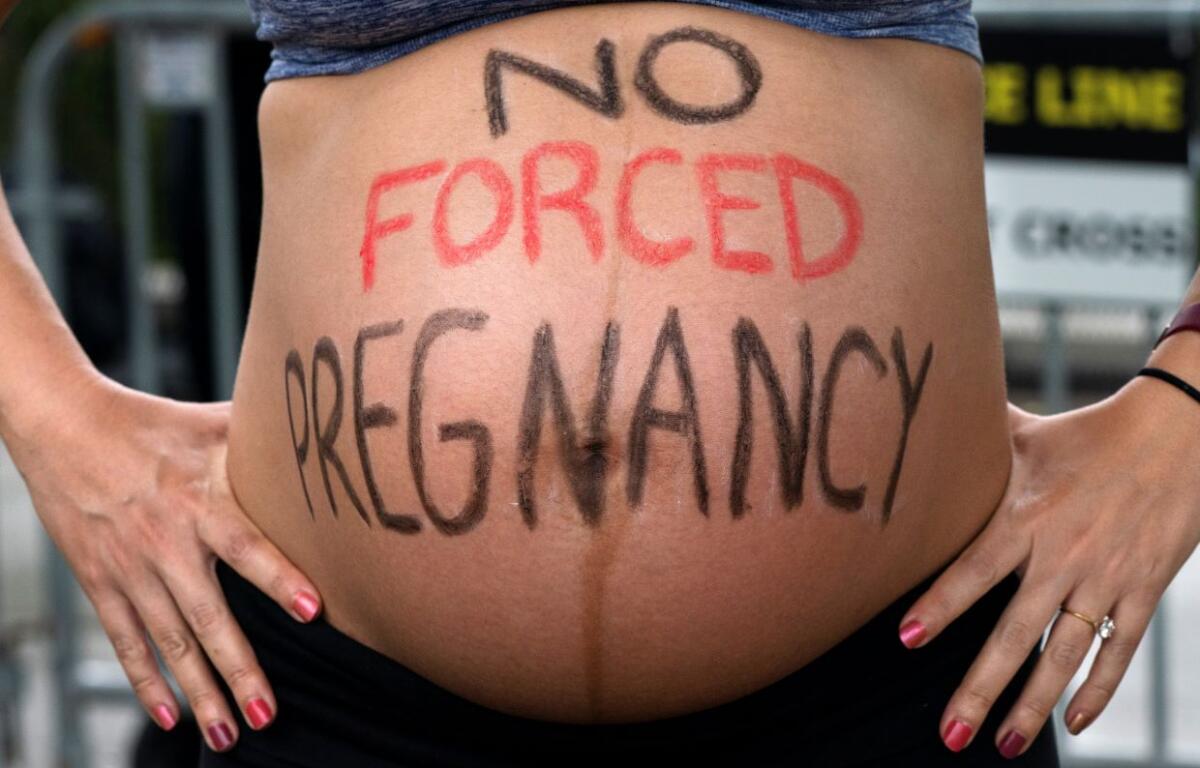 No Forced Pregnancy written on pregnant belly