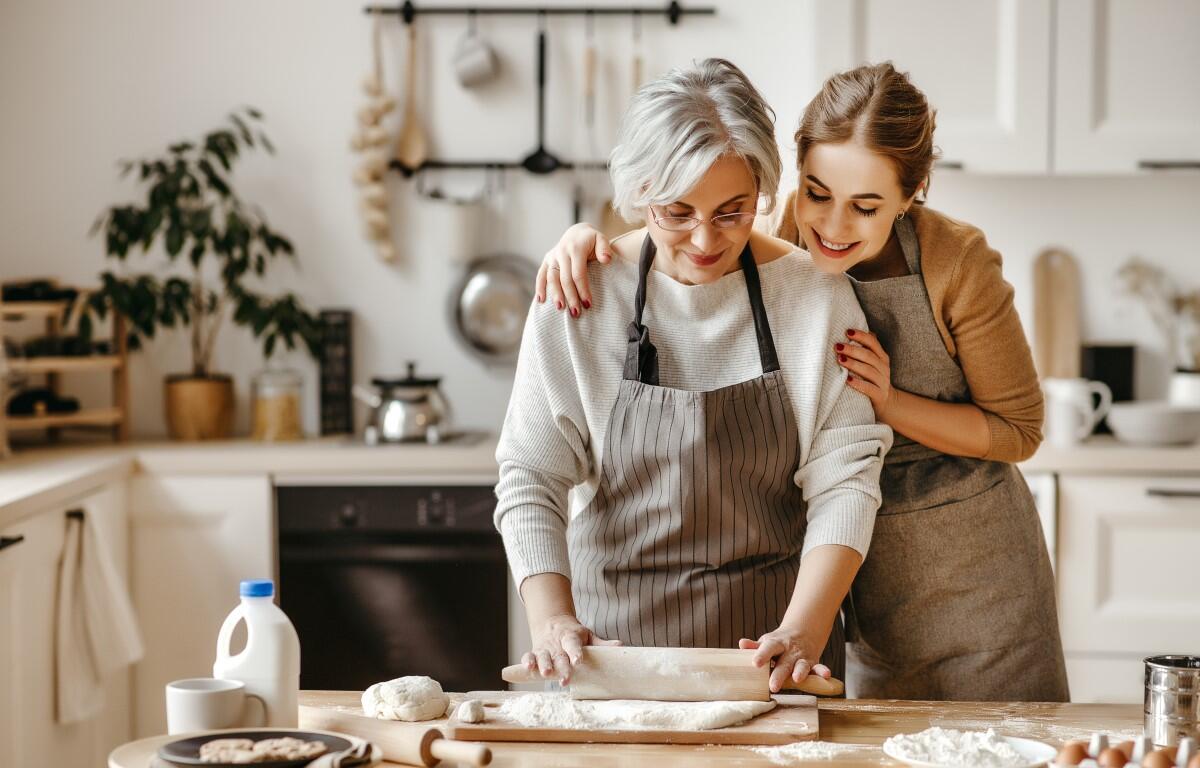 A mother and daughter cooking.