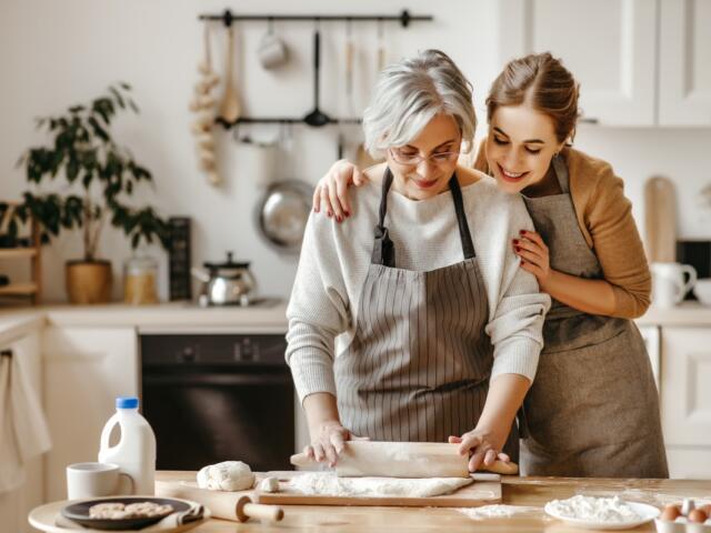 A mother and daughter cooking.