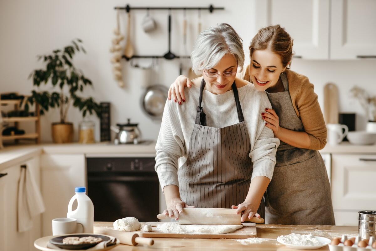 A mother and daughter cooking.