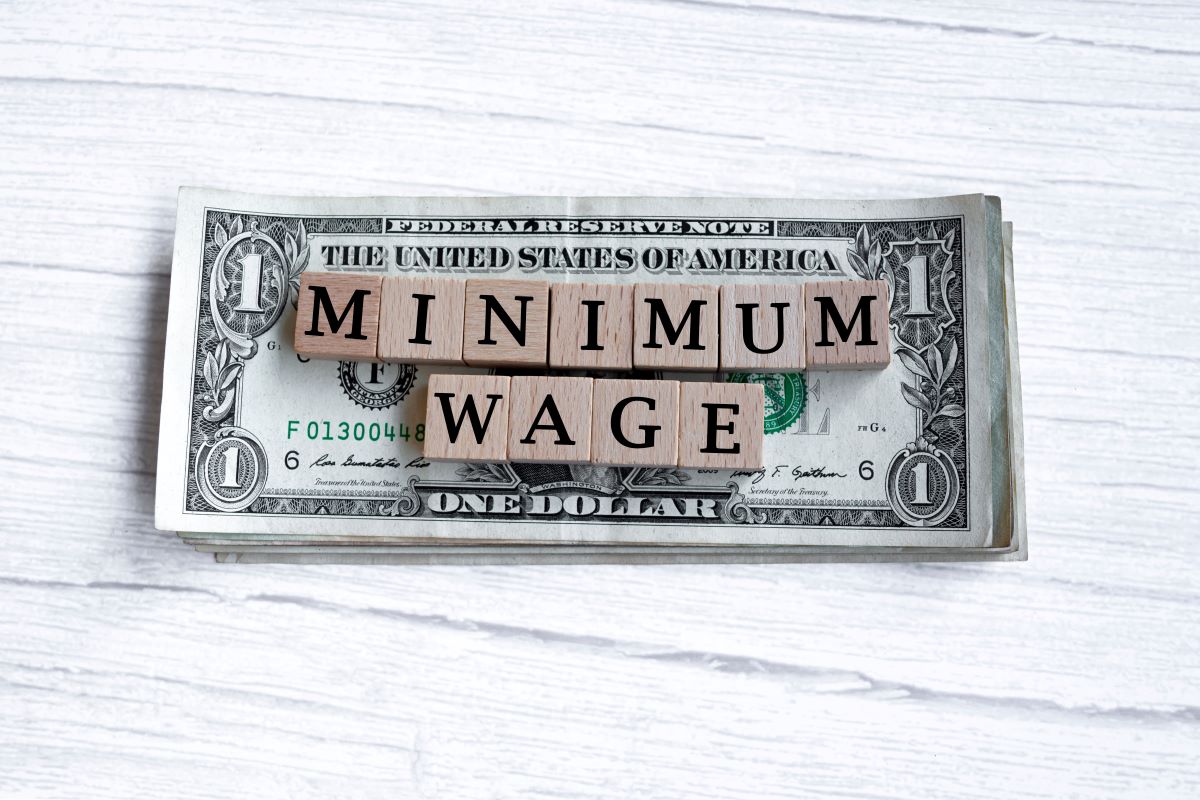 Minimum wage in letters on dollar bills