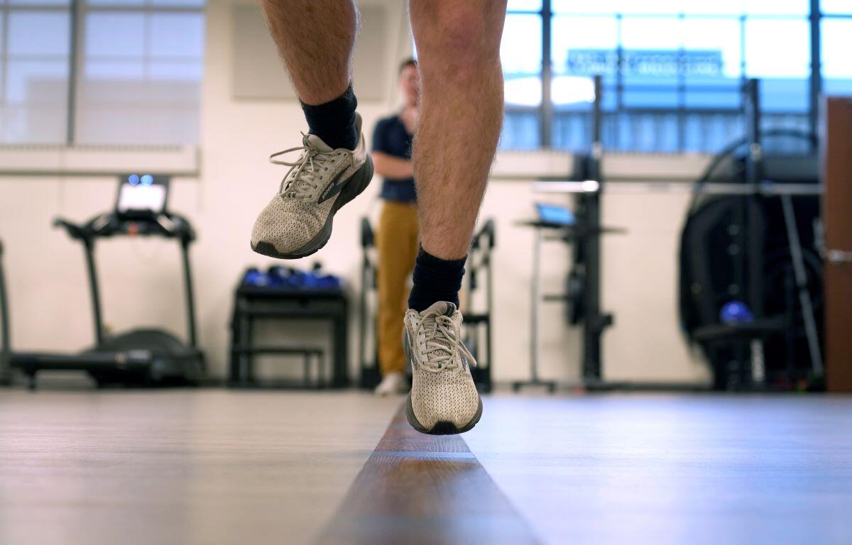 Jacob Bullard leaps in the air as part of a physical therapy exercise at WashU, Dec. 16, 2024, in St. Louis.
