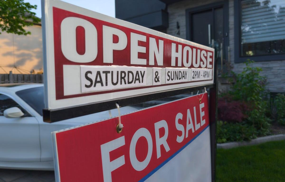 For Sale sign in front of home