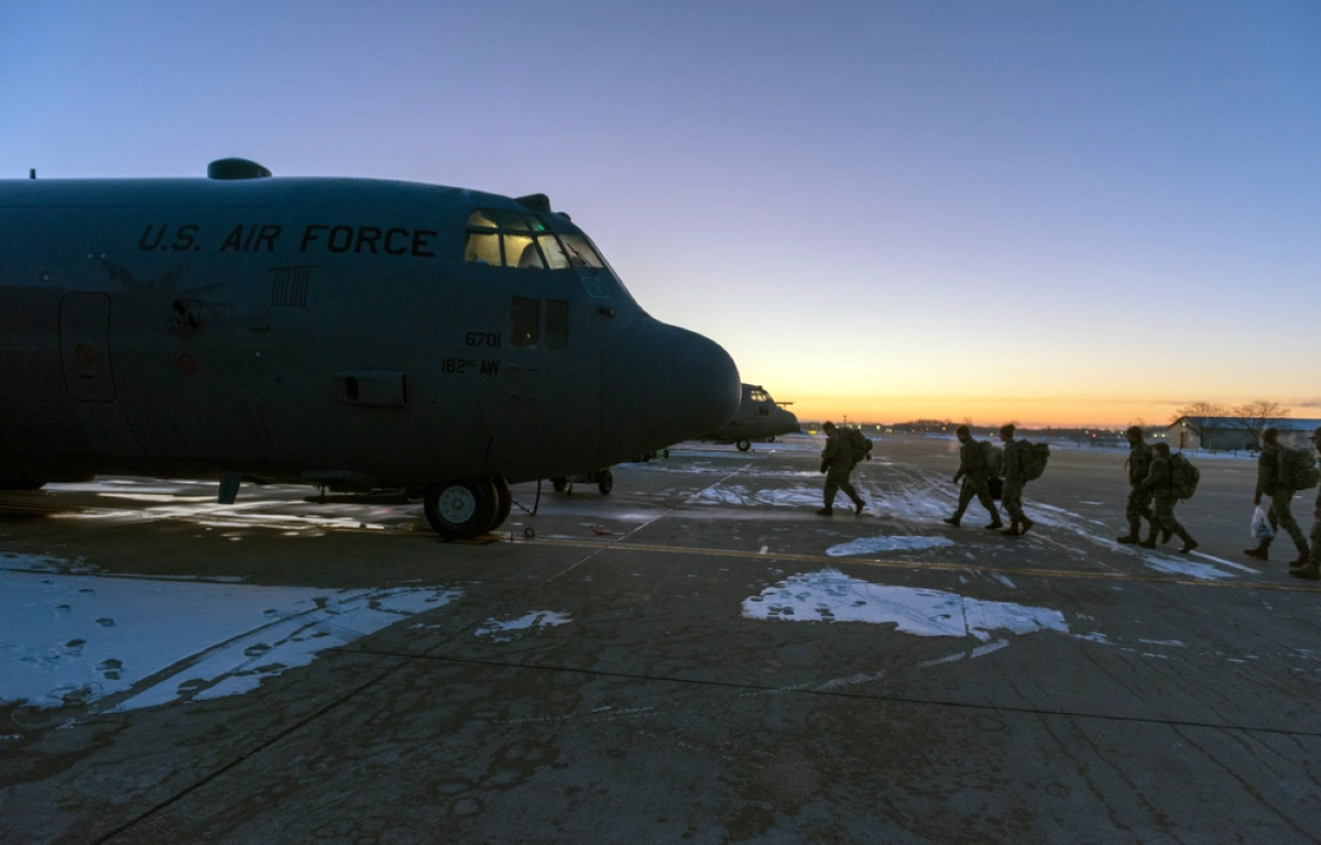 Soldiers and Airmen with the Illinois National Guard board a C-130H Hercules in Peoria, Illinois, Jan. 15, 2025, for mobilization to Washington, D.C. The Guardsmen activated in support of security operations for the 60th presidential inauguration.