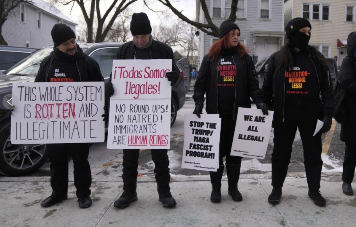 Activists with Revcom Corps Chicago hold signs outside of Hamline Elementary School after federal agents were turned away on Jan. 24, 2025, in Chicago. (AP Photo/Erin Hooley, file)