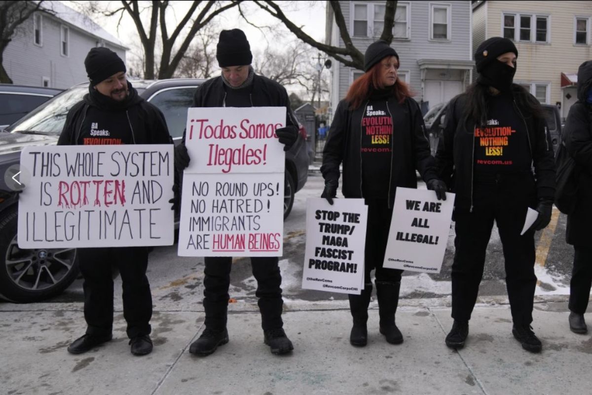 Activists with Revcom Corps Chicago hold signs outside of Hamline Elementary School after federal agents were turned away on Jan. 24, 2025, in Chicago. (AP Photo/Erin Hooley, file)