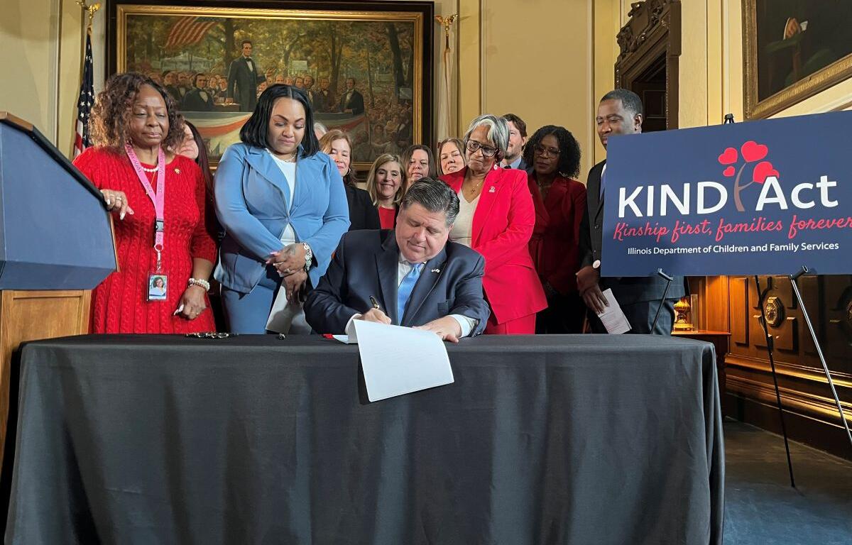 Gov. JB Pritzker signs the KIND Act Wednesday, Feb. 5, 2025, at the Illinois Capitol. The new law requires the state to prioritize family members when placing children in foster care. (Capitol News Illinois photo by Bridgette Fox)