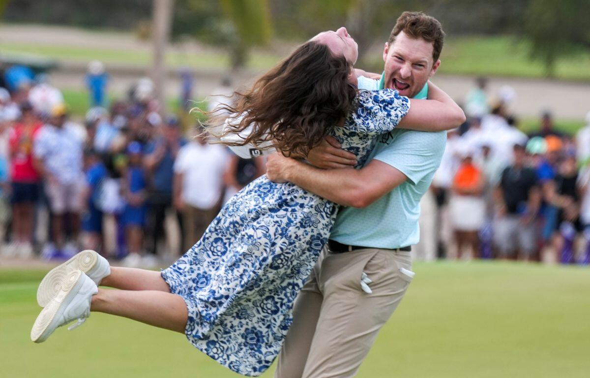 Brian Campbell, of the United States, embraces his girlfriend Kelsi McKee after winning the Mexico Open golf tournament in Puerto Vallarta, Mexico, Sunday, Feb. 23, 2025. (AP Photo/Fernando Llano)