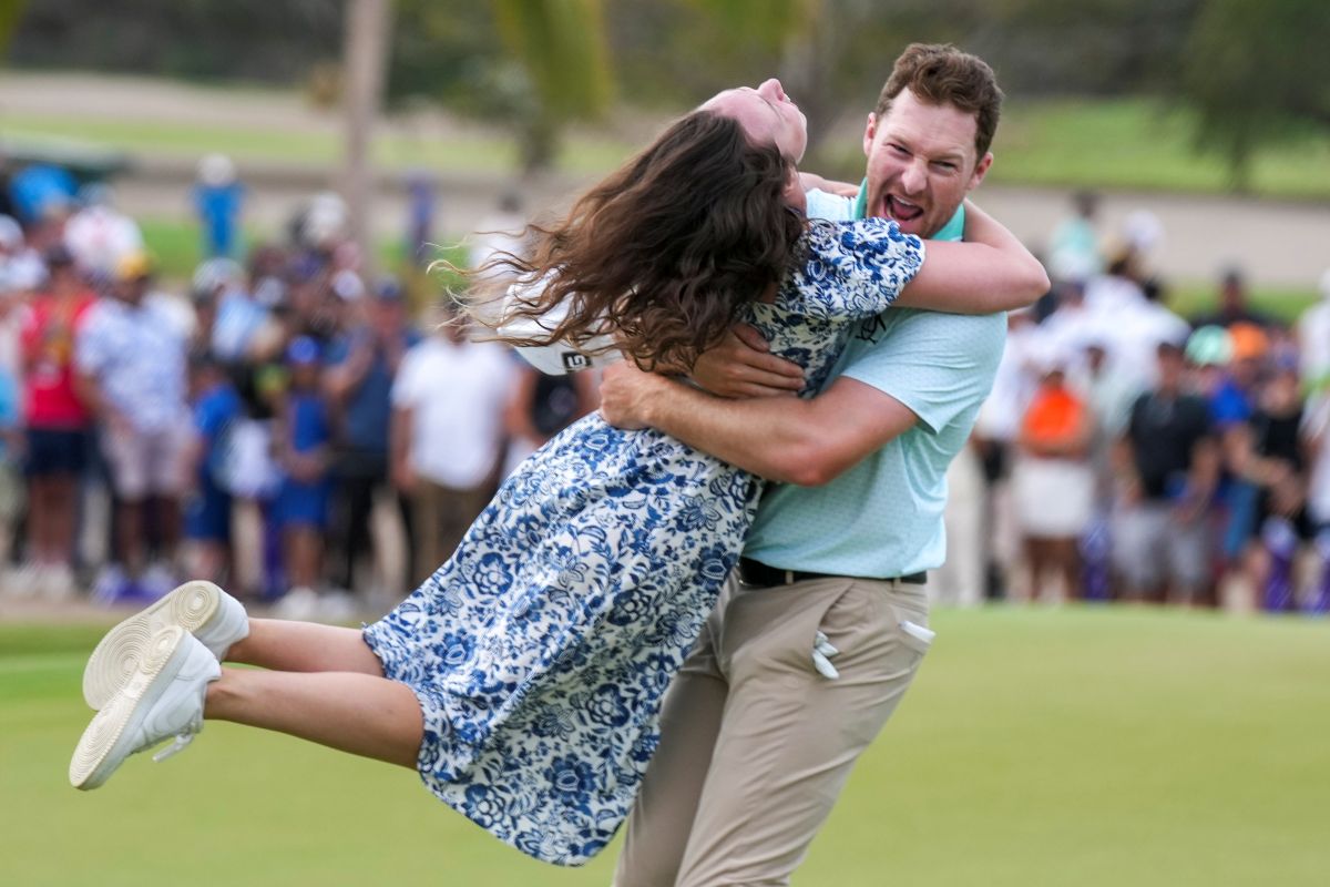 Brian Campbell, of the United States, embraces his girlfriend Kelsi McKee after winning the Mexico Open golf tournament in Puerto Vallarta, Mexico, Sunday, Feb. 23, 2025. (AP Photo/Fernando Llano)