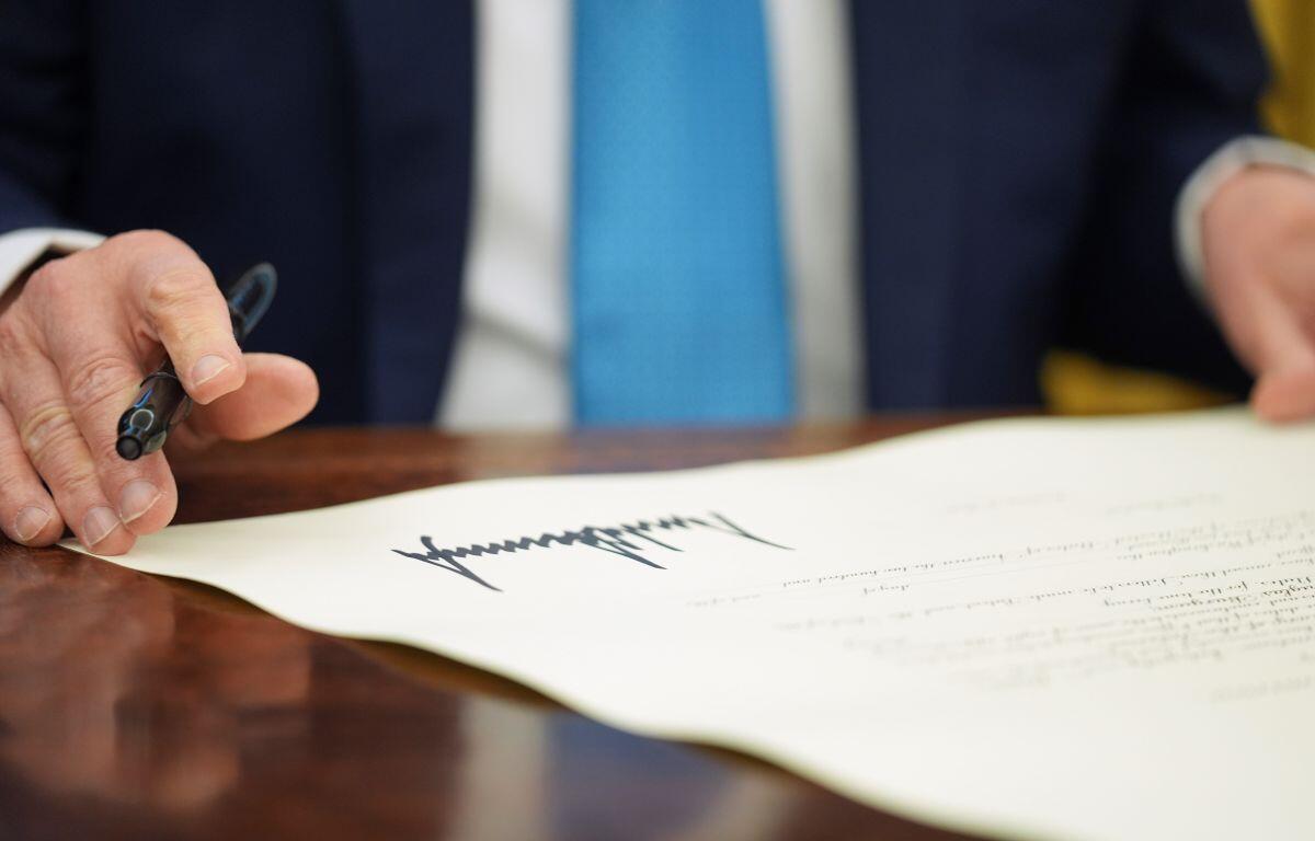 President Donald Trump pauses after signing an executive order in the Oval Office of the White House in Washington, Friday, Jan. 31, 2025. (AP Photo/Evan Vucci, File)