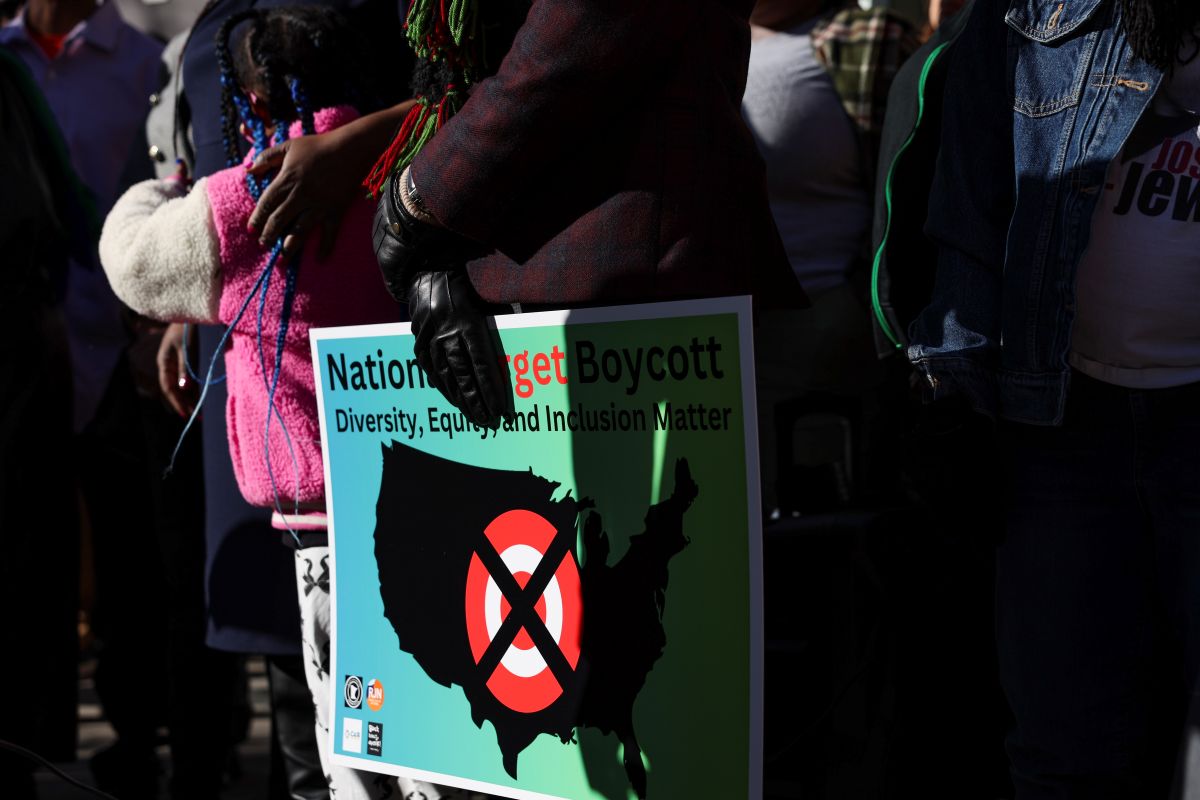 A community member holds a sign calling for a national boycott of Target stores during a news conference outside Target Corporation's headquarters Thursday, Jan. 30, 2025, in Minneapolis, Minn. (AP Photo/Ellen Schmidt, File)