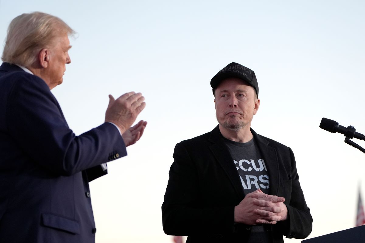 Republican presidential nominee former President Donald Trump, left, claps as Tesla and SpaceX CEO Elon Musk prepares to depart after speaking at a campaign event at the Butler Farm Show, on Oct. 5, 2024, in Butler, Pa. (AP Photo/Alex Brandon, File)