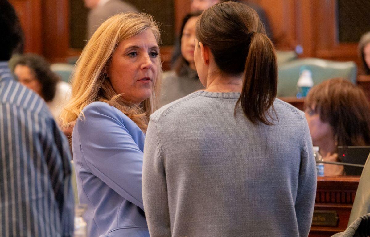 Rep. Terra Costa Howard, D- Glen Ellyn, speaks to a House colleague shortly after making a speech on April 11, 2025, in favor of her bill creating new homeschool oversight in Illinois. (Capitol News Illinois photo by Andrew Adams)