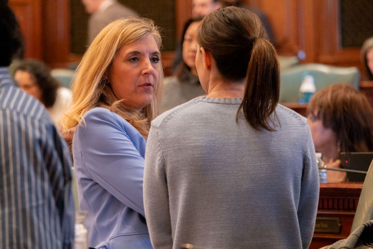 Rep. Terra Costa Howard, D- Glen Ellyn, speaks to a House colleague shortly after making a speech on April 11, 2025, in favor of her bill creating new homeschool oversight in Illinois. (Capitol News Illinois photo by Andrew Adams)