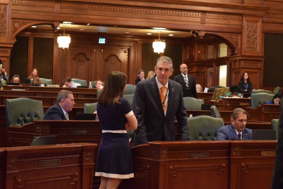 Rep. Dave Vella, D-Rockford, speaks with a colleague in the Illinois House on Wednesday, April 9, 2025. (Capitol News Illinois photo by Jade Aubrey)