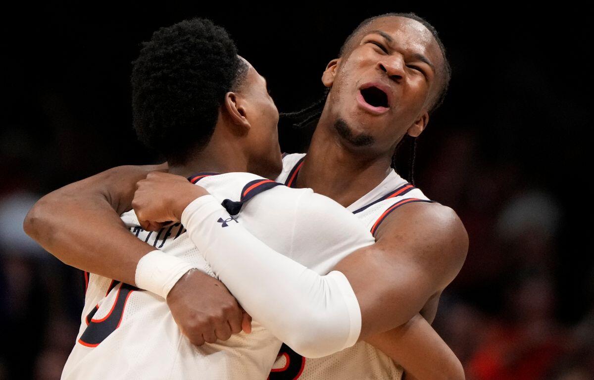Auburn's Tahaad Pettiford, left, and Miles Kelly (13) celebrate a win over Michigan State after the Elite Eight of the NCAA college basketball tournament, Sunday, March 30, 2025, in Atlanta. (AP Photo/Brynn Anderson)