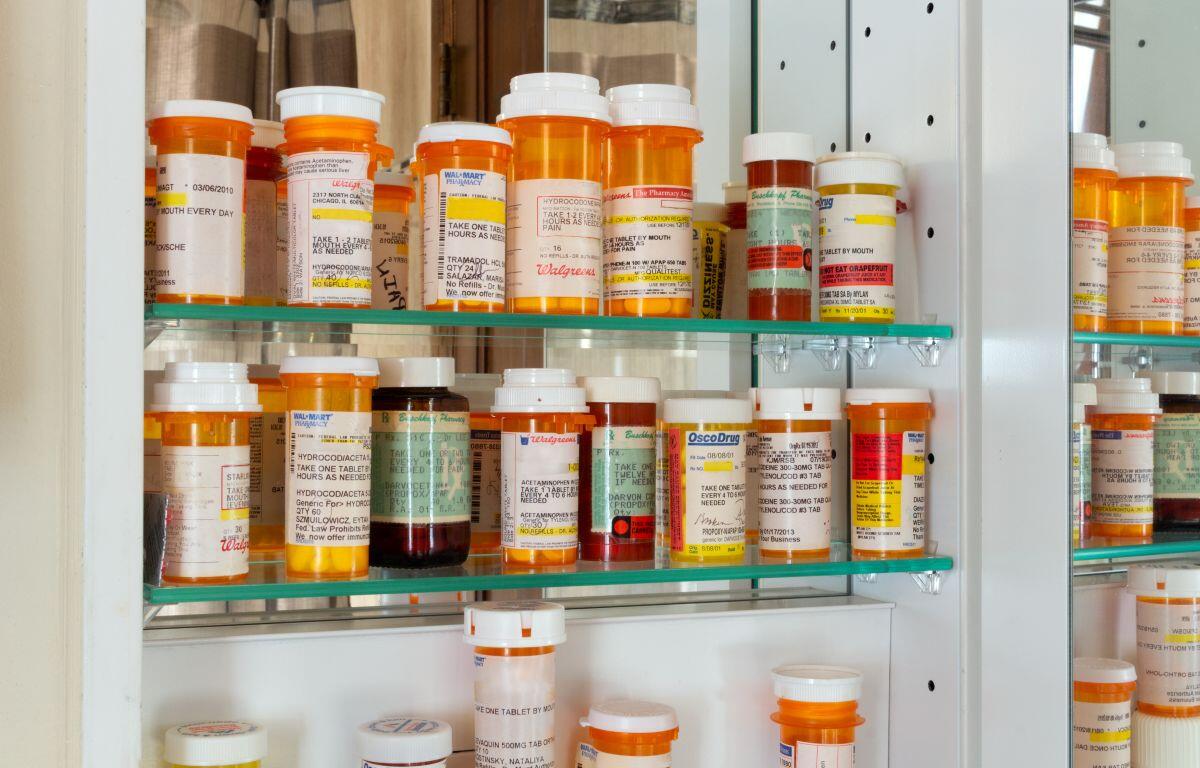 Old prescription bottles in medicine cabinet