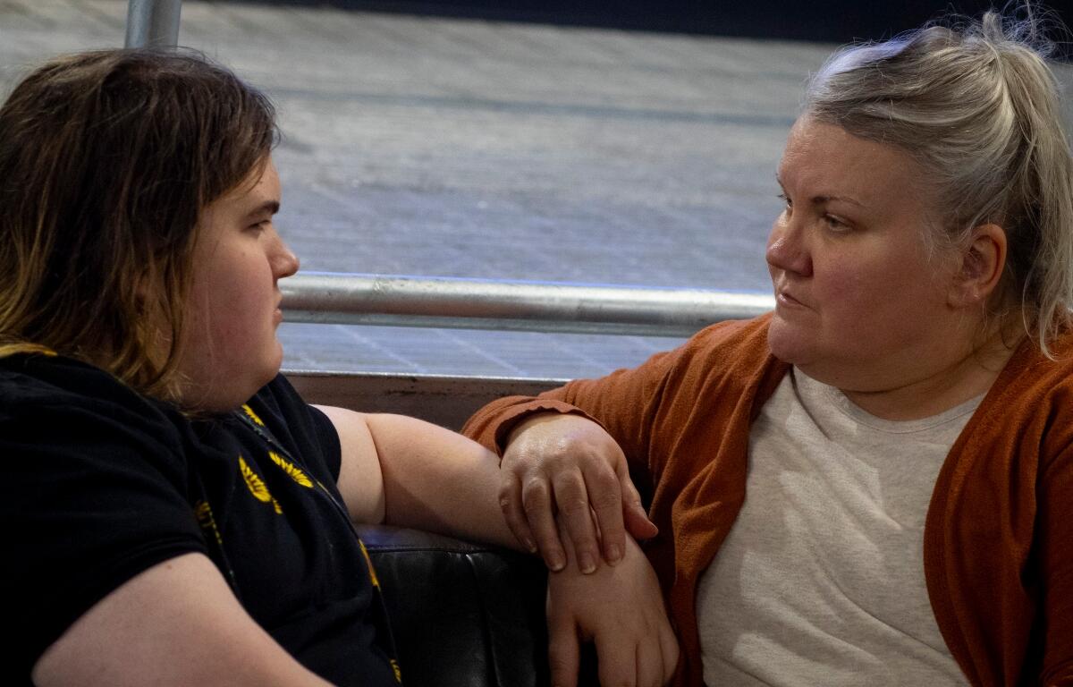 Julia Kathary (right) listens to her daughter, Connie Kathary (left), talk about her day at school at a marketplace in Indianapolis, Indiana, earlier this year. (Capitol News Illinois photo by Carly Gist for the Saluki Local Reporting Lab)