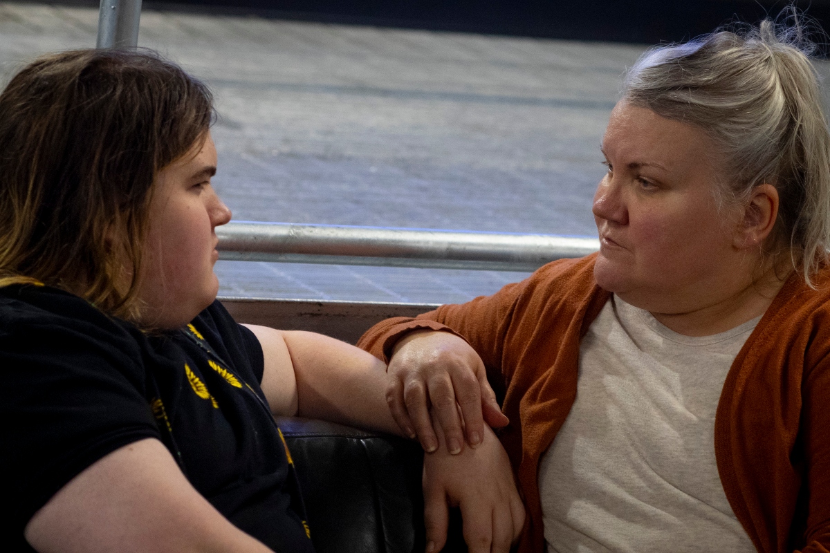 Julia Kathary (right) listens to her daughter, Connie Kathary (left), talk about her day at school at a marketplace in Indianapolis, Indiana, earlier this year. (Capitol News Illinois photo by Carly Gist for the Saluki Local Reporting Lab)