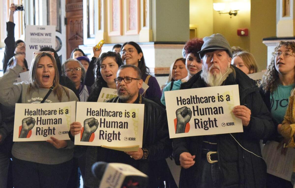 A crowd gathers at the Illinois Capitol in February to urge state lawmakers to continue to support pro-immigrant policies, including Illinois’ programs for noncitizen health care. Gov. JB Pritzker’s administration has proposed cutting one of the programs. (Capitol News Illinois photo by Jade Aubrey)