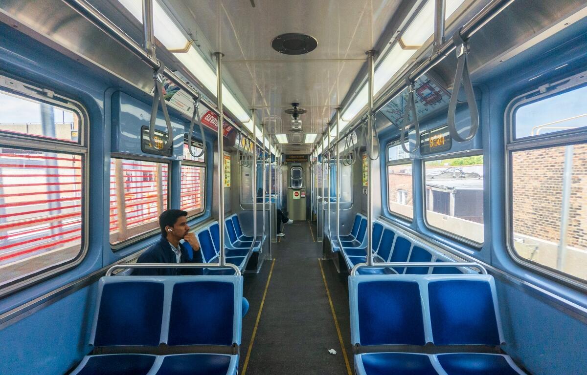 A couple of passengers ride a southbound Red Line “L” train in Chicago. (Capitol News Illinois photo by Andrew Adams)