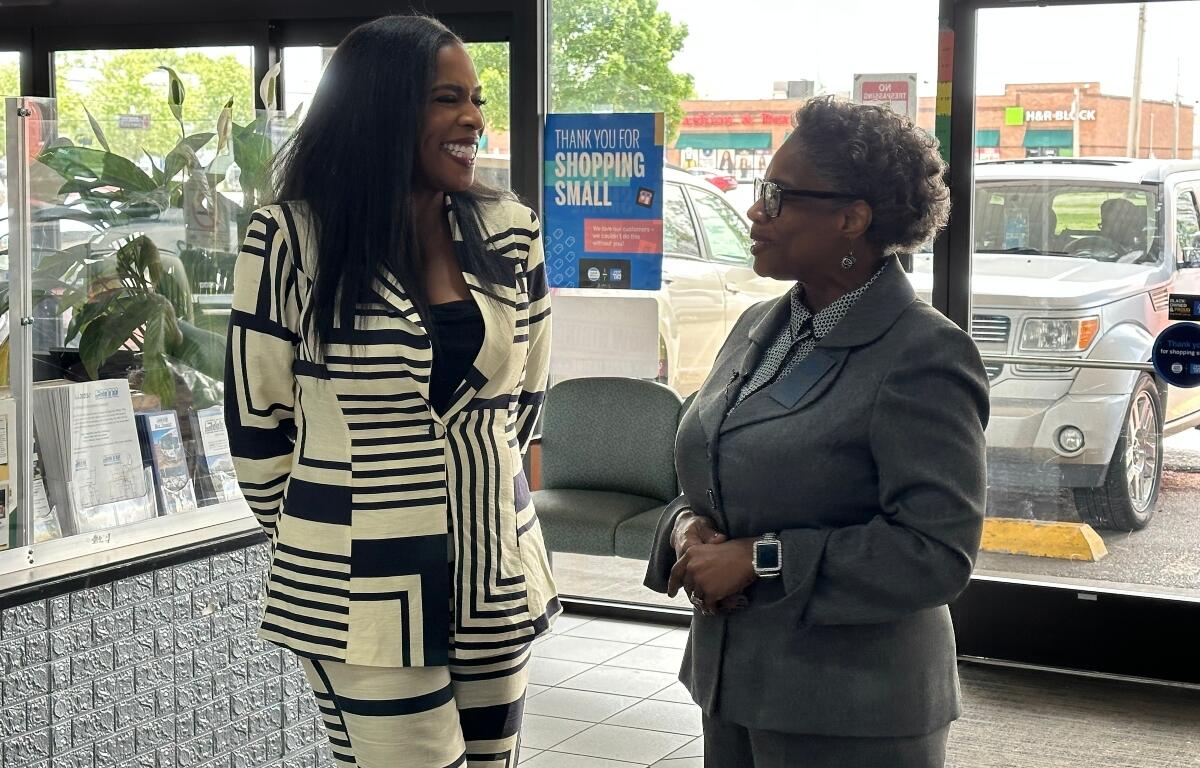 State Rep. Jehan Gordon-Booth (D-Peoria), left, speaks Tuesday in Springfield with All in One CEO Pamela Frazier.