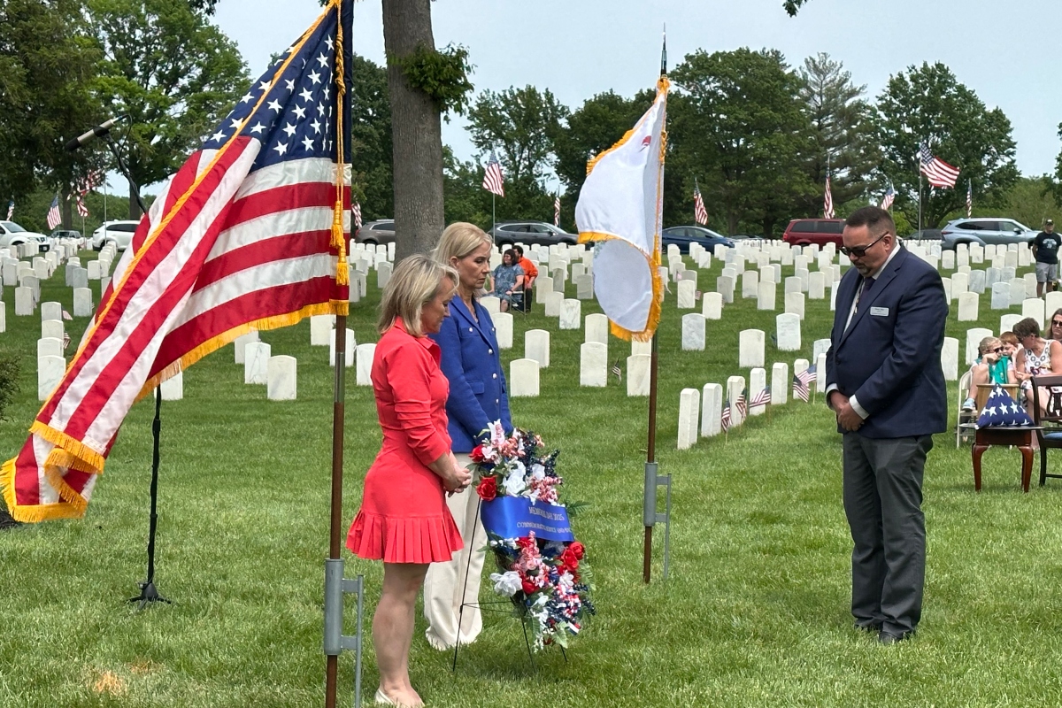 Reps. Nikki Budzinski (left, D-Springfield), and Mary Miller (R-Springfield), took part in a Memorial Day wreath-laying ceremony at Camp Butler National Cemetery.