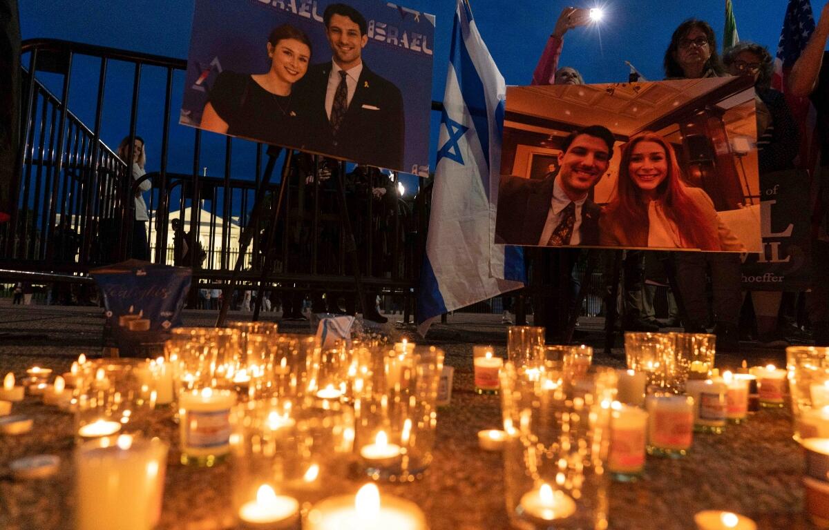 FILE - People gather to light candles in a makeshift memorial to honor Yaron Lischinsky and Sarah Milgrim who were killed as they left an event at the Capital Jewish Museum in Washington, during a candlelight vigil outside of the White House in Washington, Thursday, May 22, 2025.