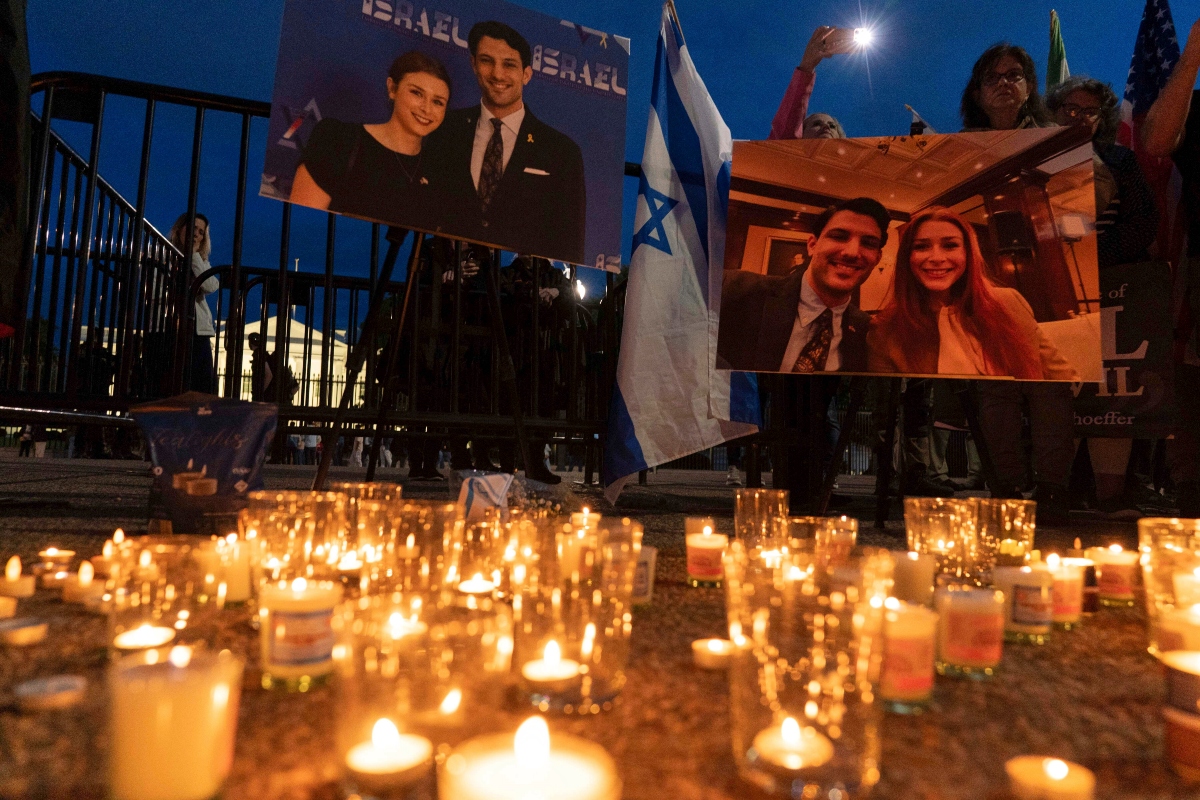 FILE - People gather to light candles in a makeshift memorial to honor Yaron Lischinsky and Sarah Milgrim who were killed as they left an event at the Capital Jewish Museum in Washington, during a candlelight vigil outside of the White House in Washington, Thursday, May 22, 2025.