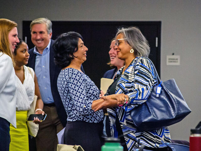 State Rep. Lisa Hernandez embraces U.S. Rep. Robin Kelly in 2022 after unseating her as Democratic Party of Illinois chair.