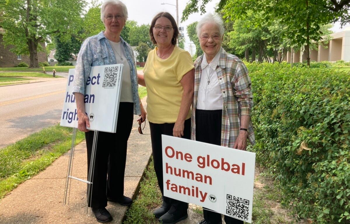 (left to right) Sister Martha Marie Kirbach, OP, coworker Roberta Fones, and Sister Georgiana Stubner, OP, were among the dozen Springfield Dominican Sisters and friends who placed signs with Catholic Social Teaching messages around the perimeter of the Dominican Sisters’ property in Springfield