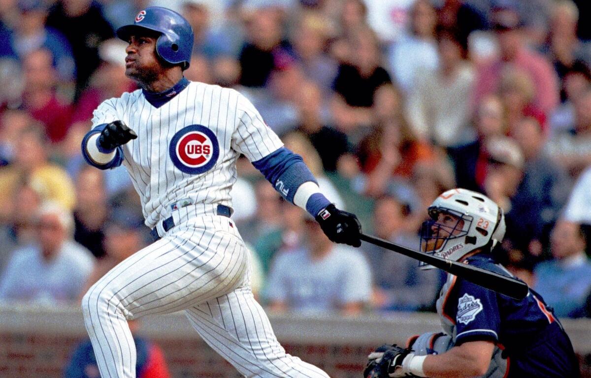 FILE - Chicago Cubs' Sammy Sosa (21) and San Diego Padres catcher Phil Nevin watch Sosa's game-winning three-run homer with one out in the ninth on June 2, 1999 in Chicago. (AP Photo/Stephen J. Carrera, File)