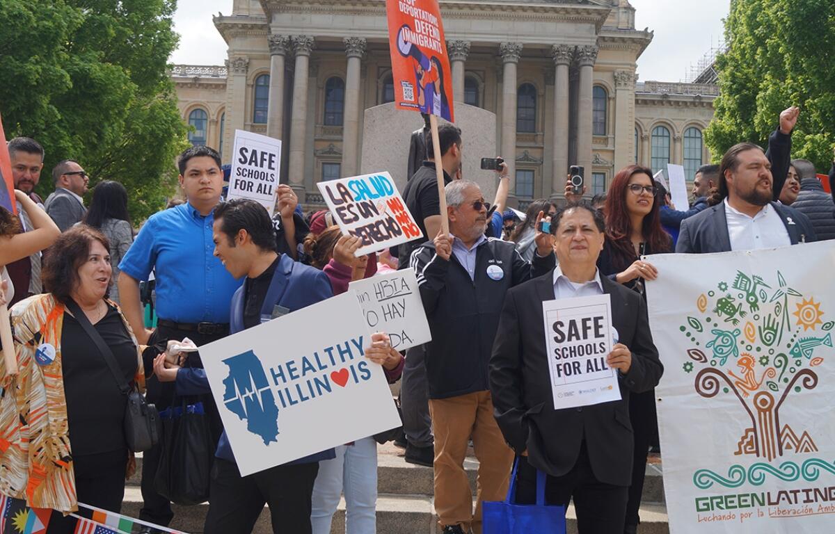 Immigrant rights advocates demonstrate outside the Illinois Statehouse for legislation protecting rights of noncitizens, including a bill meant to ensure the right of a free public K-12 education, regardless of a child’s immigration status. (Capitol News Illinois photo by Peter Hancock)