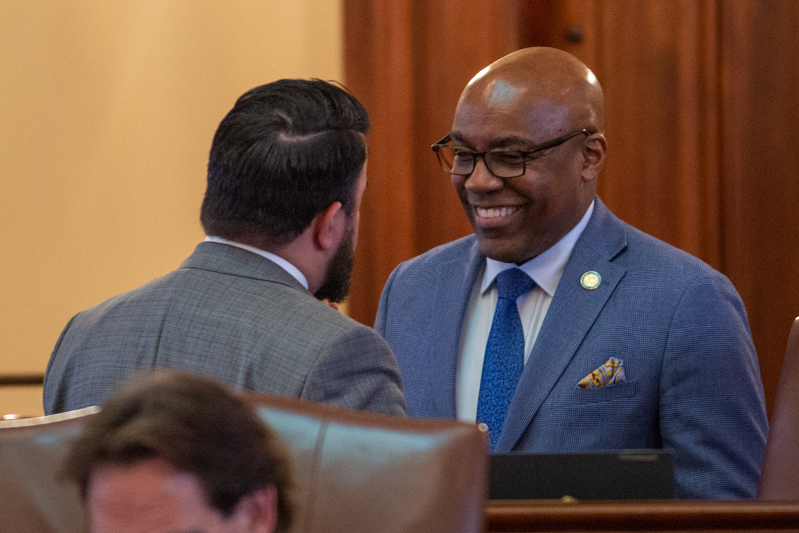 Illinois Attorney General Kwame Raoul speaks to state Sen. Omar Aquino, D-Chicago, on the floor of the Illinois Senate on May 30, 2025. (Capitol News Illinois photo by Jerry Nowicki)