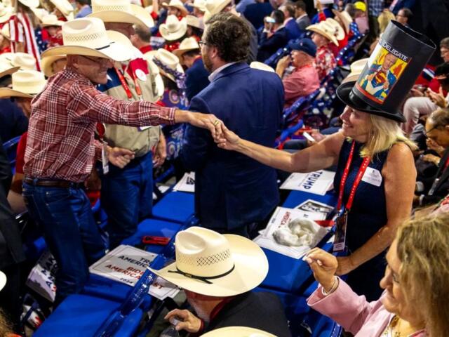 Illinois delegate Susan Sweeney dances with a member from the Texas delegation, which was notable for its coordinated hats, at the Republican National Convention in Milwaukee in July 2024. (Capitol News Illinois photo by Andrew Adams)