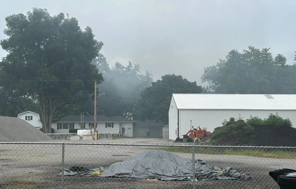 Smoke is seen in the distance after a house exploded Sunday in Warrensburg.