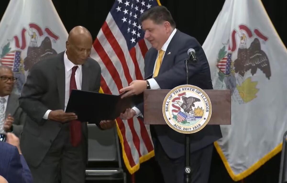 Gov JB Pritzker gives former Illinois Secretary of State Jesse White a proclamation in honor of Chicago's state office building being named the "Jesse White State of Illinois Office Building"