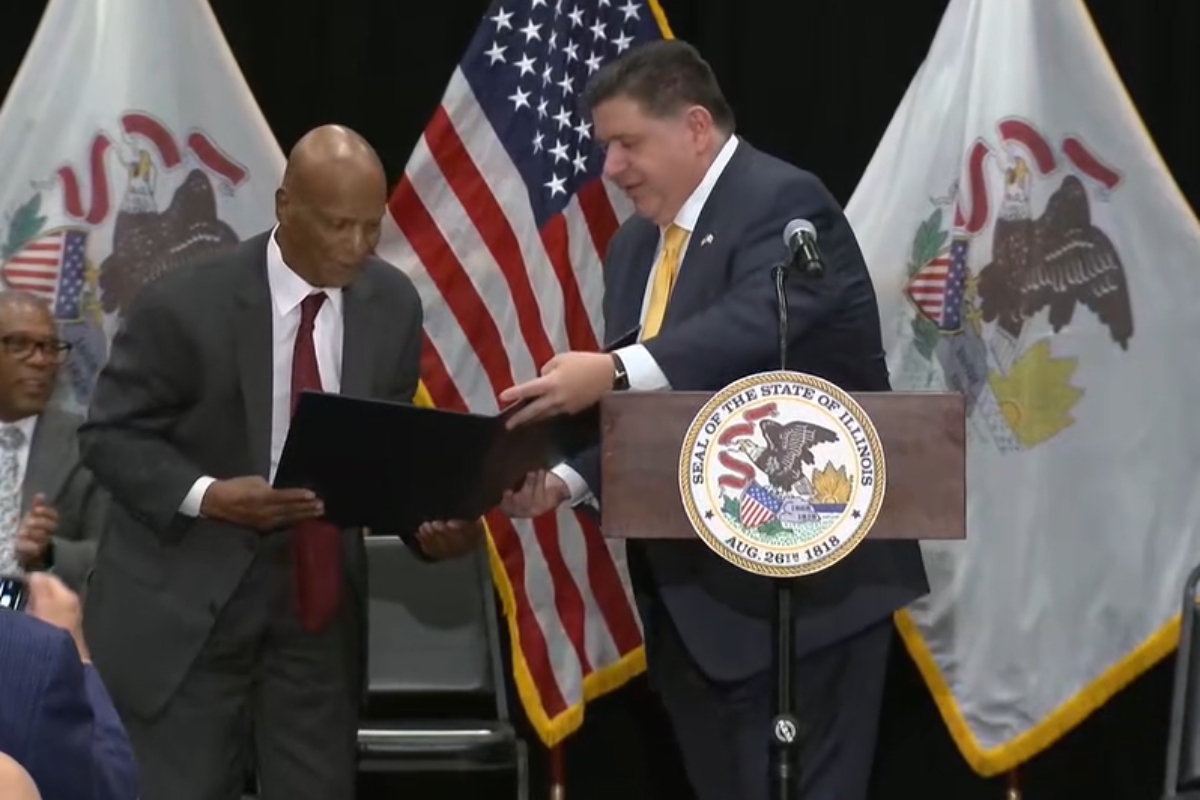 Gov JB Pritzker gives former Illinois Secretary of State Jesse White a proclamation in honor of Chicago's state office building being named the "Jesse White State of Illinois Office Building"