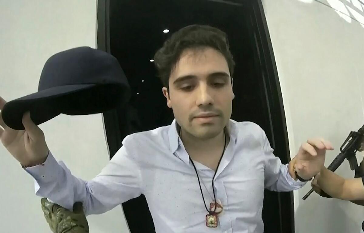 FILE - This frame grab from video, provided by the Mexican government, shows Ovidio Guzman Lopez being detained in Culiacan, Mexico, Oct. 17, 2019. (CEPROPIE via AP File)