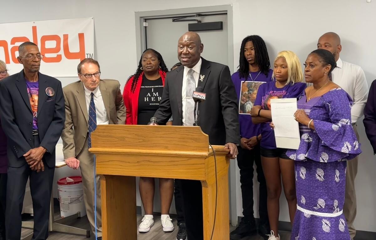 Attorney Benjamin Crump, at podium, speaks on Governer Pritzker signing "Sonya's Bill" into law. The law was named after a woman who was killed by a Sangamon County Sheriffs Deputy.
